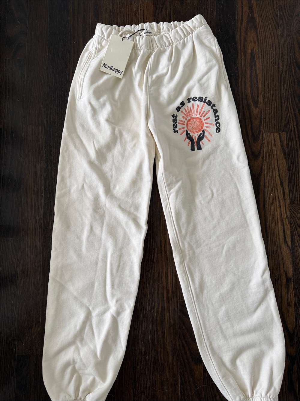 Madhappy White Sweatpants with Sunrise 'Rise as Resistance' Graphic
